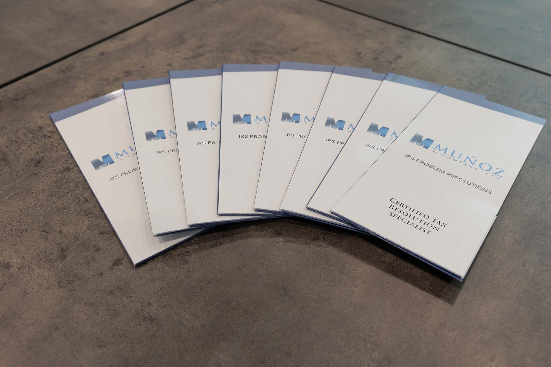 Munoz & Company, CPA brochures laid out on a desk